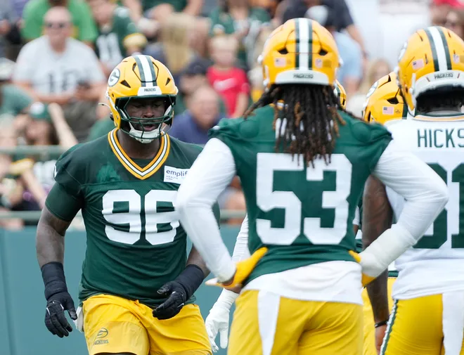 Green Bay Packers defensive tackle Colby Wooden (96) and defensive end Arron Mosby (53) run through a drill during the second day of training camp on Thursday, July 24, 2025, at Ray Nitschke Field in Ashwaubenon, Wis.