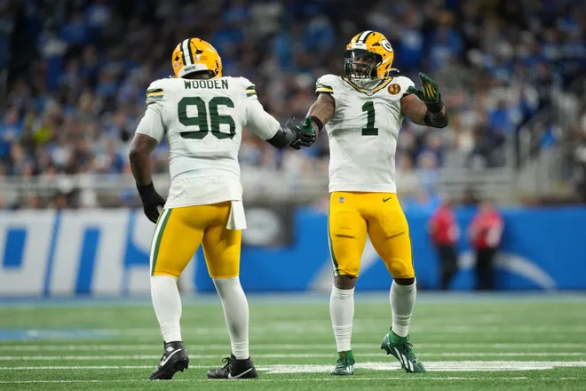 DETROIT, MICHIGAN - NOVEMBER 27: Colby Wooden #96 of the Green Bay Packers reacts with Micah Parsons #1 during the fourth quarter against the Detroit Lions at Ford Field on November 27, 2025 in Detroit, Michigan. (Photo by Nic Antaya/Getty Images)