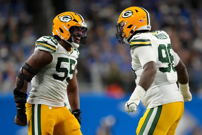 DETROIT, MICHIGAN - DECEMBER 05: Kingsley Enagbare #55 and Colby Wooden #96 of the Green Bay Packers react to a play against the Detroit Lions during the first quarter in the game at Ford Field on December 05, 2024 in Detroit, Michigan. (Photo by Nic Antaya/Getty Images)