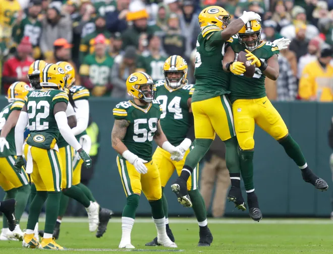 Green Bay Packers linebacker Kingsley Enagbare, far right, celebrates recoving a fumble on 4-yard line with defensive tackle Colby Wooden (96) against the Tampa Bay Buccaneers during their football game Sunday, December 17, 2023, at Lambeau Field in Green Bay, Wis.