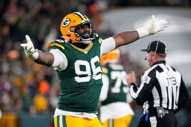 Nov 24, 2024; Green Bay, Wisconsin, USA; Green Bay Packers defensive lineman Colby Wooden (96) celebrates a play during the fourth quarter against the San Francisco 49ers at Lambeau Field. Mandatory Credit: Jeff Hanisch-Imagn Images