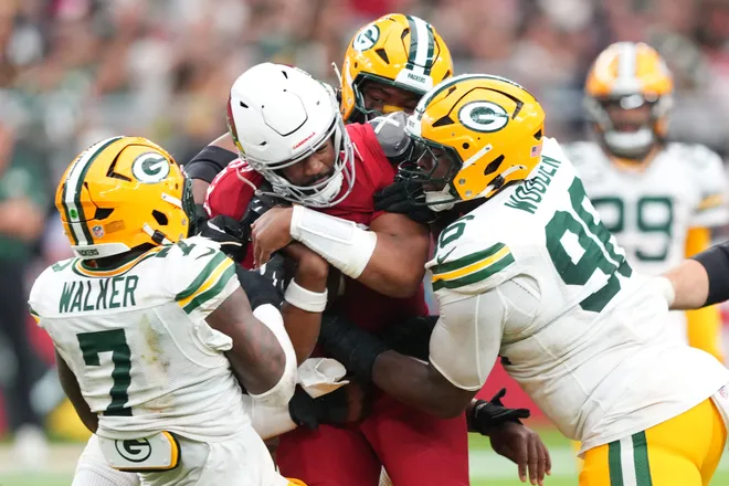 Oct 19, 2025; Glendale, Arizona, USA; Green Bay Packers linebacker Quay Walker (7) and Green Bay Packers defensive end Colby Wooden (96) sack Arizona Cardinals quarterback Jacoby Brissett (7) during the second half at State Farm Stadium. Mandatory Credit: Joe Camporeale-Imagn Images