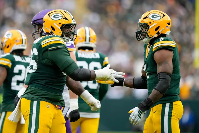Nov 23, 2025; Green Bay, Wisconsin, USA; Green Bay Packers defensive tackle Colby Wooden (96) and defensive end Micah Parsons (1) react after a defensive play Minnesota Vikings during the second half at Lambeau Field. Mandatory Credit: Kayla Wolf-Imagn Images