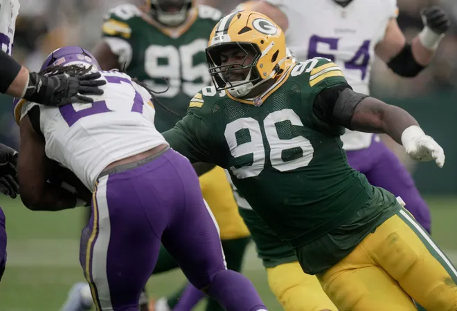 Green Bay Packers defensive tackle Colby Wooden (96) stuffs Minnesota Vikings running back Jordan Mason (27) during the fourth quarter of their game Sunday, November 23, 2025 at Lambeau Field in Green Bay, Wisconsin. The Green Bay Packers beat the Minnesota Vikings 23-6