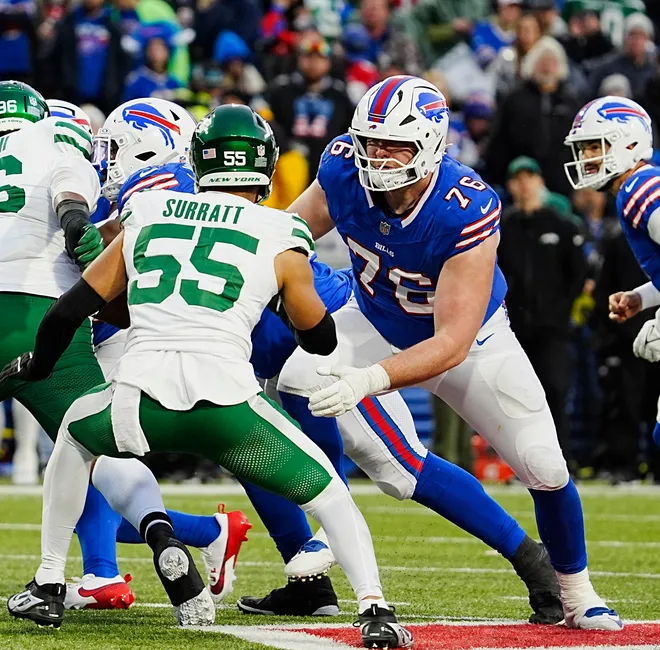 Buffalo Bills guard David Edwards (76) keeps his eyes on New York Jets linebacker Chazz Surratt (55) during second half action at the Bills home game against the New York Jets at Highmark Stadium in Orchard Park on Dec. 29, 2024.