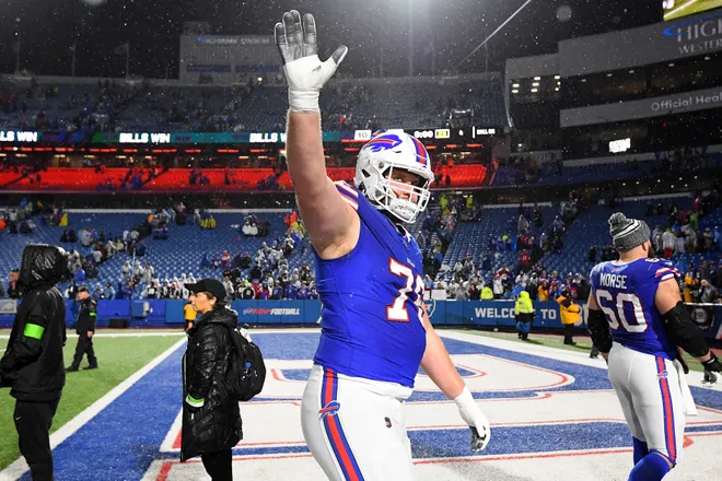 ORCHARD PARK, NEW YORK - DECEMBER 17: David Edwards #76 of the Buffalo Bills waves to fans after his team's 31-10 win against the Dallas Cowboys at Highmark Stadium on December 17, 2023 in Orchard Park, New York. (Photo by Rich Barnes/Getty Images)