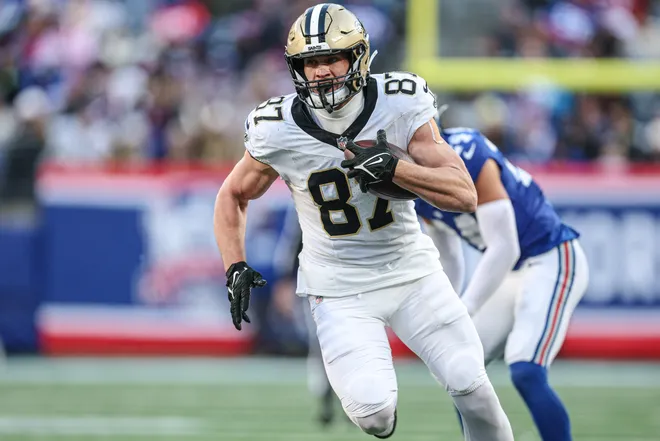 Dec 8, 2024; East Rutherford, New Jersey, USA; New Orleans Saints tight end Foster Moreau (87) makes a catch during the second half in front of New York Giants safety Dane Belton (24) at MetLife Stadium. Mandatory Credit: Vincent Carchietta-Imagn Images