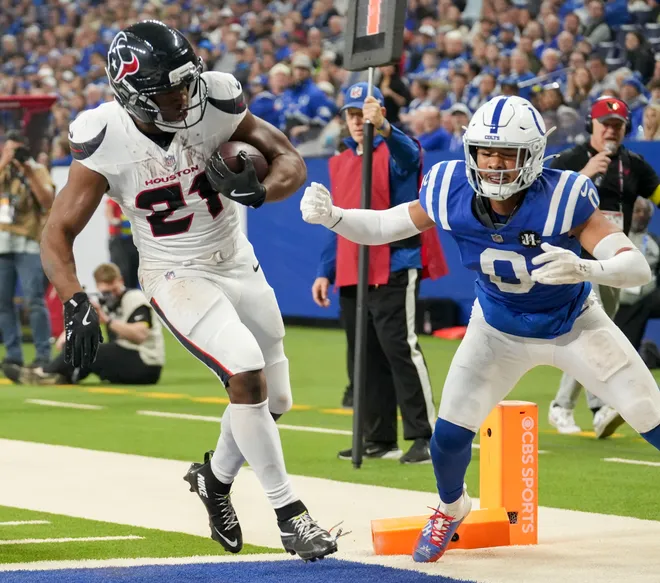 Nov 30, 2025; Indianapolis, Indiana, USA; Houston Texans running back Nick Chubb (21) rushes past Indianapolis Colts safety Camryn Bynum (0) for a touchdown at Lucas Oil Stadium. Mandatory Credit: Christine Tannous-USA TODAY Network via Imagn Images