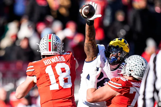 Michigan defensive lineman Rayshaun Benny (26) tries to block a pass from Ohio State quarterback Will Howard (18) during the second half at Ohio Stadium in Columbus, Ohio on Saturday, Nov. 30, 2024.