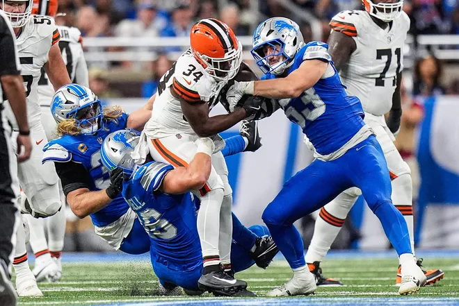 Detroit Lions linebacker Trevor Nowaske (53), right, and linebacker Alex Anzalone (34), left, linebacker Jack Campbell (46) tackle Cleveland Browns running back Jerome Ford (34) during the second half at Ford Field in Detroit on Sunday, Sept. 28, 2025.