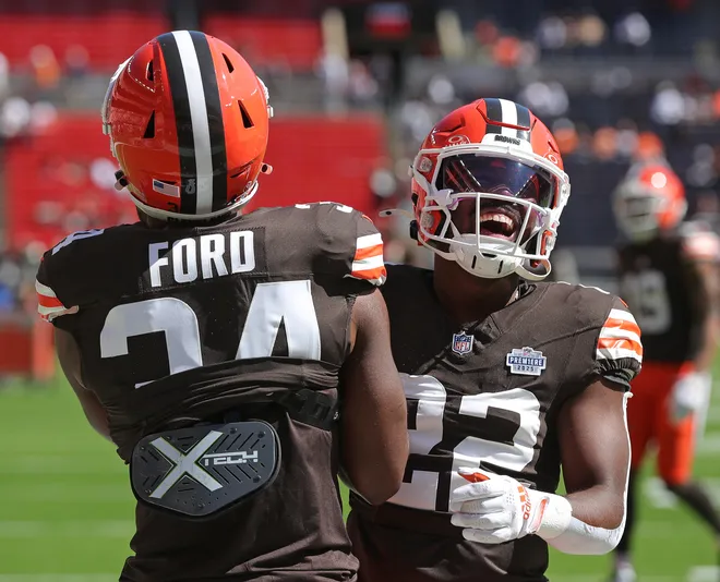 Cleveland Browns running backs Dylan Sampson (22) and Jerome Ford (34) share a lighthearted moment before a game against the Cincinnati Bengals on Sept. 7, 2025, in Cleveland.