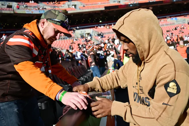Nov 19, 2023; Cleveland, Ohio, USA; Cleveland Browns running back Jerome Ford, right, signs an autograph for a fan before the game between the Browns and the Pittsburgh Steelers at Cleveland Browns Stadium. Mandatory Credit: Ken Blaze-USA TODAY Sports