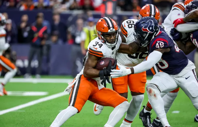 Jan 13, 2024; Houston, Texas, USA; Cleveland Browns running back Jerome Ford (34) and Houston Texans linebacker Christian Harris (48) fight for the ball during the second quarter in a 2024 AFC wild card game at NRG Stadium. Mandatory Credit: Troy Taormina-USA TODAY Sports