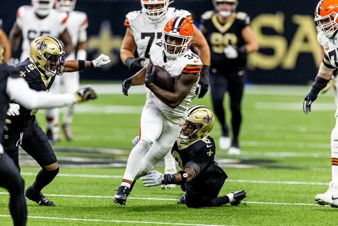 Nov 17, 2024; New Orleans, Louisiana, USA; Cleveland Browns running back Jerome Ford (34) rushes against New Orleans Saints safety Ugo Amadi (0) during the first half at Caesars Superdome. Mandatory Credit: Stephen Lew-Imagn Images