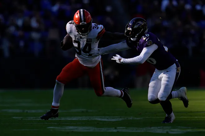 Nov 12, 2023; Baltimore, Maryland, USA; Cleveland Browns running back Jerome Ford (34) runs with the ball as Baltimore Ravens safety Geno Stone (26) defends during the second quarter at M&T Bank Stadium. Mandatory Credit: Jessica Rapfogel-USA TODAY Sports