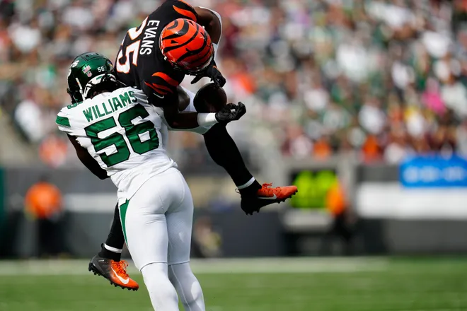 New York Jets linebacker Quincy Williams (56) catches Cincinnati Bengals running back Chris Evans (25) mid-air on a catch in the third quarter of the NFL Week 3 game between the Jets and the Bengals at MetLife Stadium in East Rutherford, N.J., on Sunday, Sept. 25, 2022.