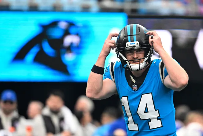 Oct 26, 2025; Charlotte, North Carolina, USA; Carolina Panthers quarterback Andy Dalton (14) calls a play in the fourth quarter against the Buffalo Bills at Bank of America Stadium. Mandatory Credit: Bob Donnan-Imagn Images