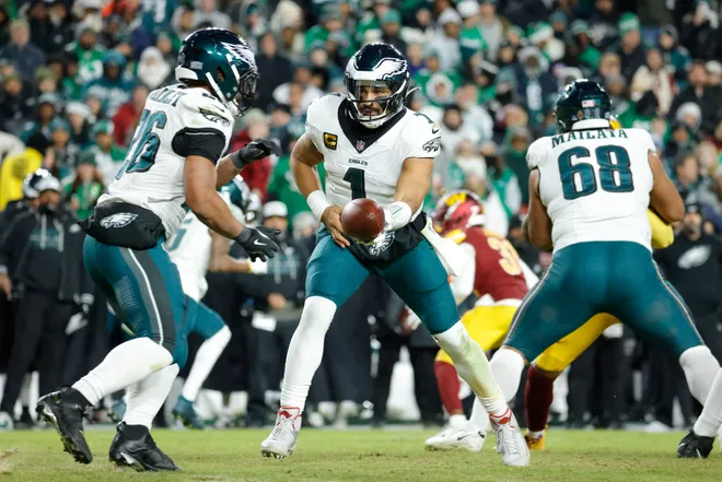 Dec 20, 2025; Landover, Maryland, USA; Philadelphia Eagles quarterback Jalen Hurts (1) hands the ball to Eagles running back Saquon Barkley (26) against the Washington Commanders during the second half at Northwest Stadium. Mandatory Credit: Amber Searls-Imagn Images