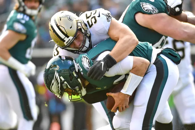 Jan 1, 2023; Philadelphia, Pennsylvania, USA; Philadelphia Eagles quarterback Gardner Minshew (10) is sacked by New Orleans Saints linebacker Kaden Elliss (55) during the first quarter at Lincoln Financial Field. Mandatory Credit: Eric Hartline-USA TODAY Sports