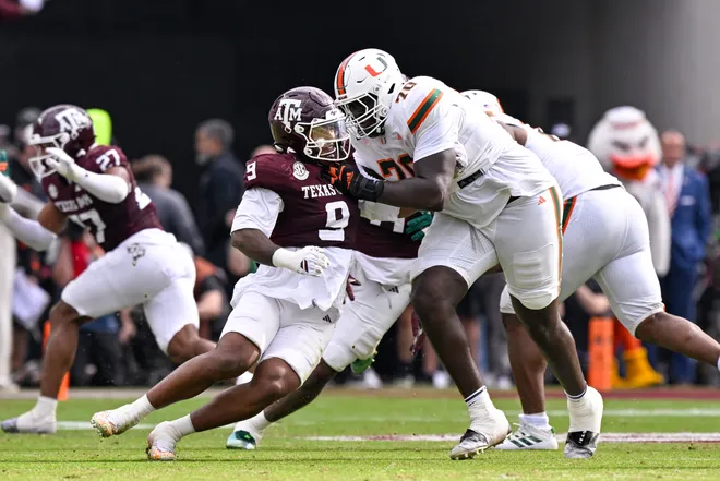 Dec 20, 2025; College Station, TX, USA; Texas A&M Aggies defensive end Cashius Howell (9) rushes the line past Miami Hurricanes offensive lineman Markel Bell (70) during the game between the Aggies and the Hurricanes at Kyle Field. Mandatory Credit: Jerome Miron-Imagn Images