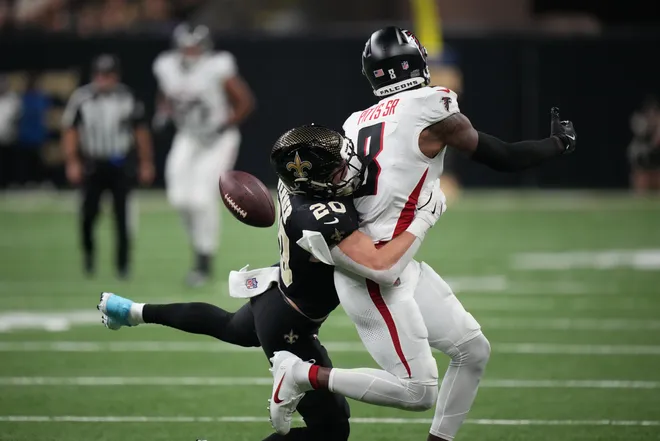 Nov 23, 2025; New Orleans, Louisiana, USA; New Orleans Saints linebacker Pete Werner (20) breaks up the pass to Atlanta Falcons tight end Kyle Pitts Sr. (8) during the first half at Caesars Superdome. Mandatory Credit: Matthew Hinton-Imagn Images