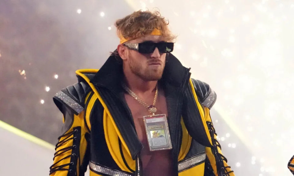 Apr 2, 2022; Arlington, TX, USA; Logan Paul (left) and The Miz enter the arena to face The Mysterios (not pictured) during WrestleMania at AT&T Stadium. Mandatory Credit: Joe Camporeale-Imagn Images