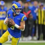 Los Angeles Rams quarterback Matthew Stafford (9) rolls out against the Arizona Cardinals during the first half at SoFi Stadium.