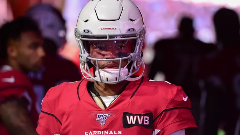 Kyler Murray stands on the field before an Arizona Cardinals home game at State Farm Stadium. Kyler Murray Vikings trade.