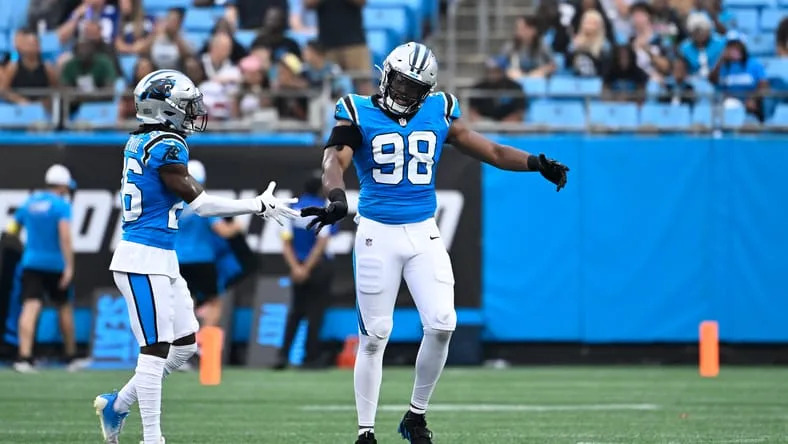 D.J. Wonnum reacts with teammate Chau Smith-Wade during a Panthers preseason game. ex-Vikings free agents 2026