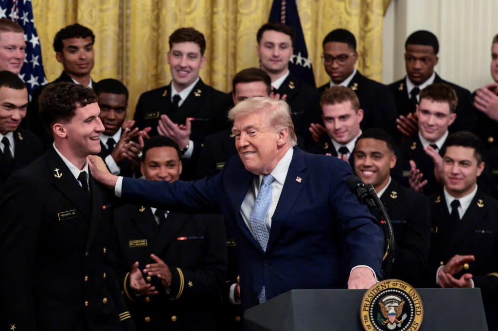 President Trump speaks to the US Navy football team at the White House. REUTERS