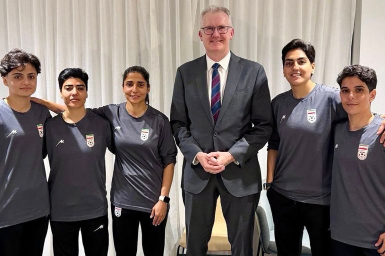An undated and unplaced photo released by Australia's Department of Home Affairs shows Home Affairs minister Tony Burke (3/R) with five Iranian women football players who applied for asylum after competing in the Women's Asia Cup tournament being played in Australia. Australia has granted asylum to some of Iran's visiting women's football team over fears they faced persecution at home for not singing the national anthem before a match, Home Affairs Minister Tony Burke said on Tuesday. (Photo by HANDOUT / AUSTRALIAN DEPARTMENT OF HOME AFFAIRS / AFP) / ----EDITORS NOTE ----RESTRICTED TO EDITORIAL USE MANDATORY CREDIT " AFP PHOTO / DEPARTMENT OF HOME AFFAIRS" NO MARKETING NO ADVERTISING CAMPAIGNS - DISTRIBUTED AS A SERVICE TO CLIENTS