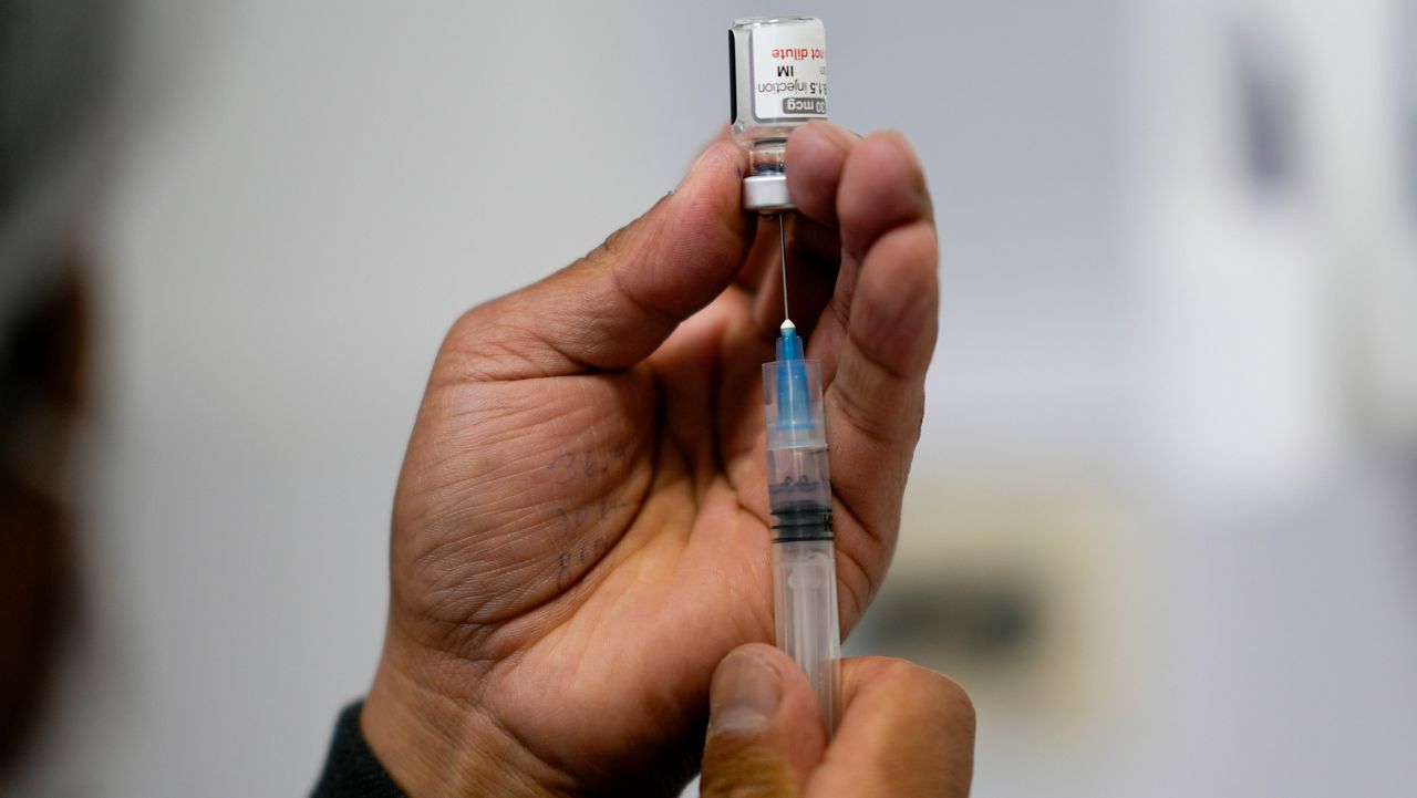 FILE - A healthcare worker prepares a shot of the Pfizer COVID-19 vaccine in La Paz, Bolivia, Jan. 7, 2025. (AP Photo/Juan Karita, File)