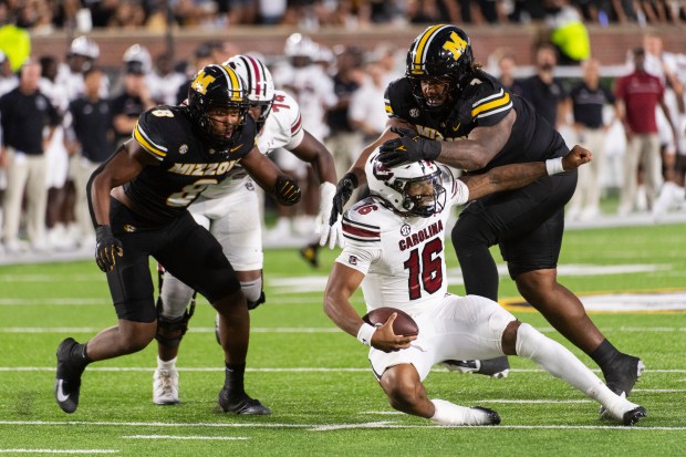 South Carolina quarterback LaNorris Sellers (16) is sacked by Missouri's Chris McClellan, top right, during the first half of a game Saturday, Sept. 20, 2025, in Columbia, Mo. (AP Photo/L.G. Patterson)