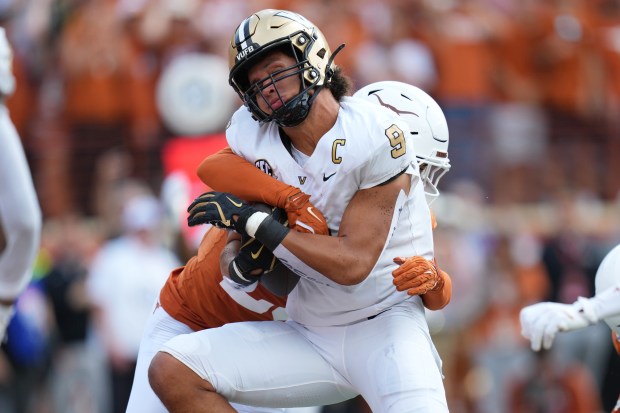 Vanderbilt tight end Eli Stowers (9) is hit by Texas defensive back Graceson Littleton (29) as he scores a touchdown during the first half of an NCAA college football game in Austin, Texas, Saturday, Nov. 1, 2025. (AP Photo/Eric Gay)