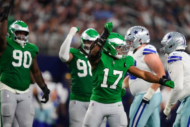 Eagles linebacker Nakobe Dean, center, celebrates a sack of Dallas Cowboys quarterback Dak Prescott during a Nov. 23, 2025, game in Arlington, Texas. (AP Photo/Tony Gutierrez)