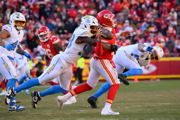 Kansas City Chiefs quarterback Patrick Mahomes (15) is sacked by Los Angeles Chargers linebacker Odafe Oweh (98) during the second half of an NFL game this past season. (AP Photo/Reed Hoffmann)