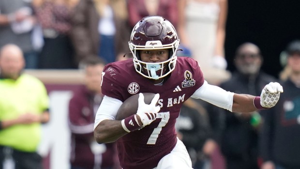 Texas A&M wide receiver KC Concepcion (7) runs the ball against Miami during the second half of the first round of the College Football Playoff, Saturday, Dec. 20, 2025, in College Station, Texas. (AP Photo/Karen Warren)