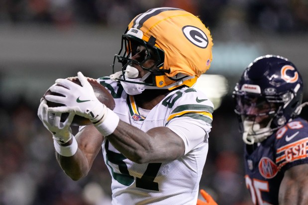 Green Bay Packers' Romeo Doubs catches a touchdown pass in front of Chicago Bears' Kyle Monangai during the second half of an NFL game Saturday, Dec. 20, 2025, in Chicago. (AP Photo/Nam Huh)