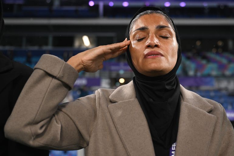 Iran coach Marziyeh Jafari salutes during the national anthem ahead of the Women's Asian Cup soccer match between Iran and the Philippines in Robina, Australia, Sunday, March 8, 2026. (Dave Hunt/AAP Image via AP)