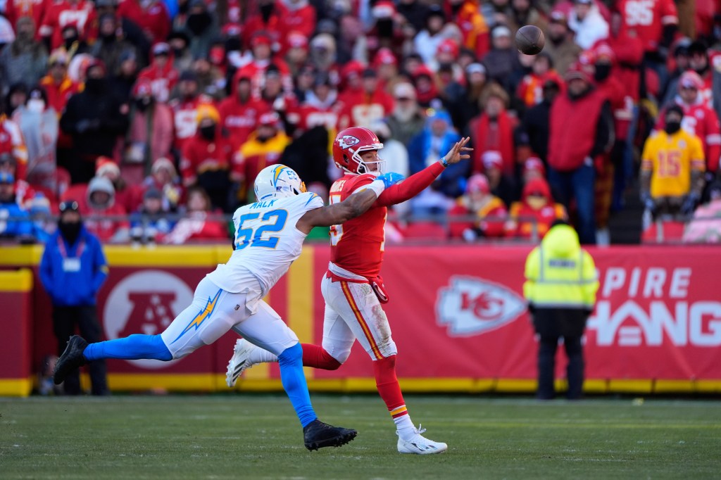 Kansas City Chiefs quarterback Patrick Mahomes throws the ball while Los Angeles Chargers outside linebacker Khalil Mack pressures him.