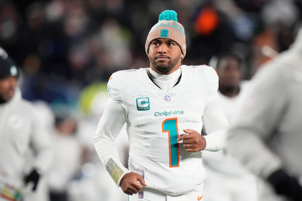 Miami Dolphins quarterback Tua Tagovailoa runs off the field during the first half of an NFL football game against the New England Patriots in Foxborough, Mass., Jan. 4, 2026.