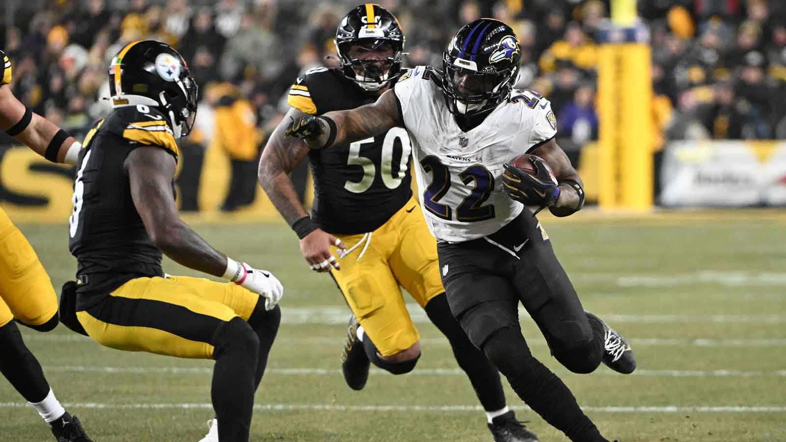 Baltimore Ravens running back Derrick Henry (22) rushes the ball past Pittsburgh Steelers linebacker Malik Harrison (50) during the first half at Acrisure Stadium.