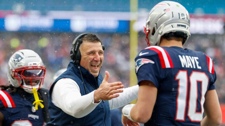 New England Patriots head coach Mike Vrabel celebrates with quarterback Drake Maye (10) after a touchdown during the first half of an NFL football game against the Buffalo Bills, Sunday, Dec. 14, 2025, in Foxborough, Mass.