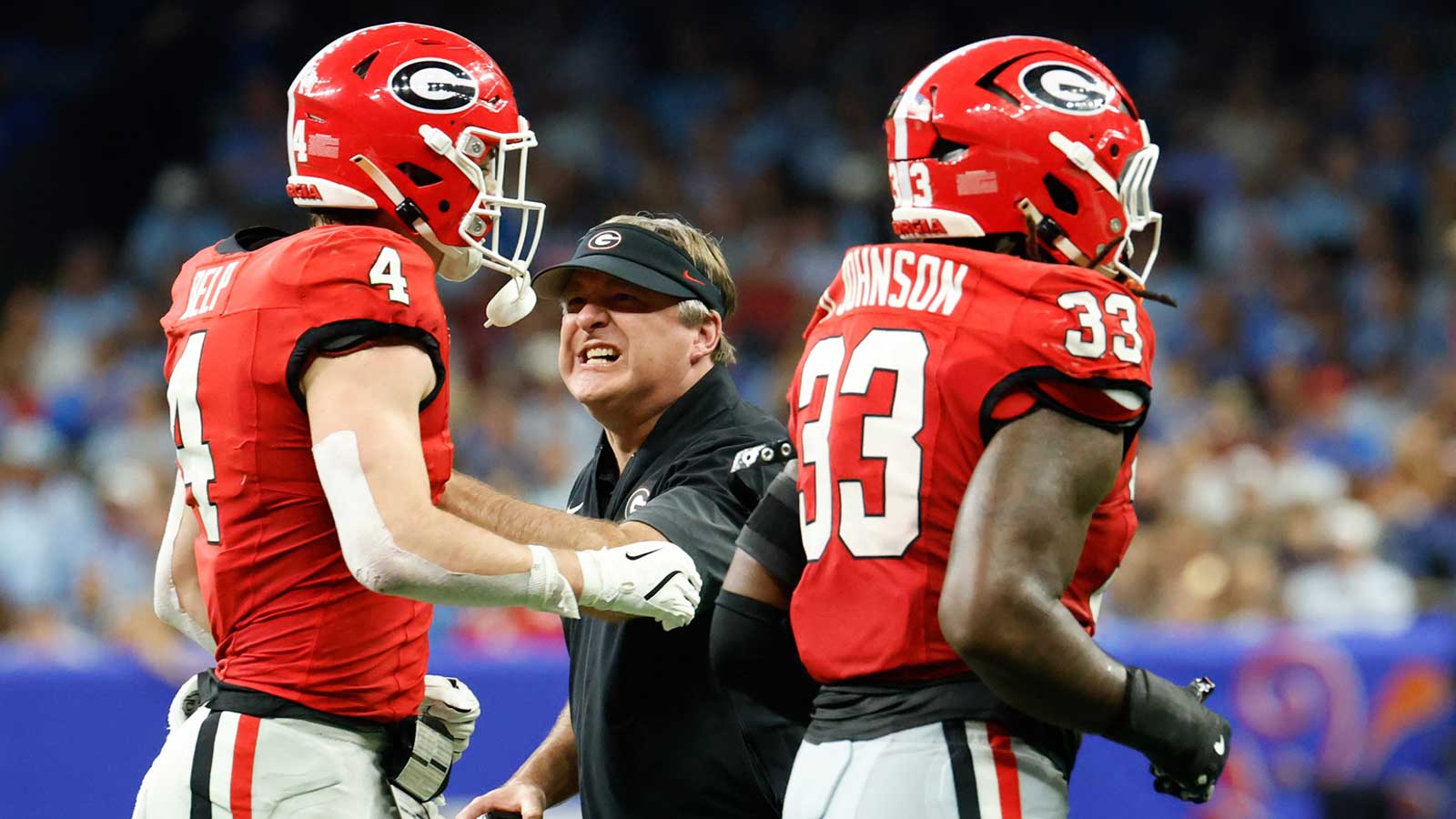 Georgia Bulldogs head coach Kirby Smart congratulates tight end Oscar Delp (4) and linebacker Quintavius Johnson (33) after a play against the Mississippi Rebels in the second quarter during the 2026 Sugar Bowl and quarterfinal game of the College Football Playoff at Caesars Superdome.