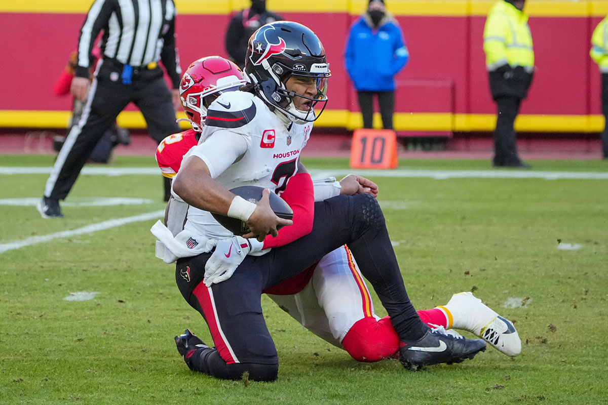 Houston Texans quarterback CJ Stroud (7) is sacked by Kansas City Chiefs cornerback Joshua Williams (2) during the second half at GEHA Field at Arrowhead Stadium.