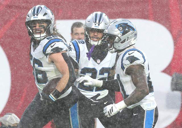 Carolina Panthers linebacker Christian Rozeboom, left, runs down the field with his teammates after intercepting a pass by Tampa Bay Buccaneers quarterback Baker Mayfield during action at Raymond James Stadium in Tampa on Jan. 3.