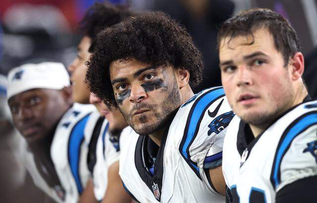 Carolina Panthers tight end Tommy Tremble, center, sits on the team’s bench during action against the Tampa Bay Buccaneers at Raymond James Stadium in Tampa, FL.on Saturday, January 3, 2026. The Buccaneers defeated the Panthers 16-14.