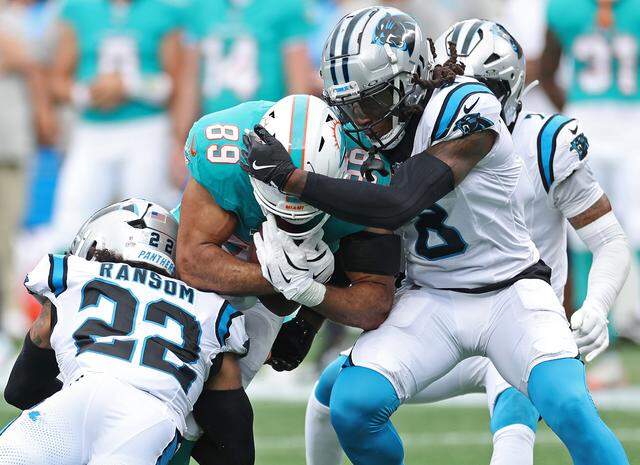 Carolina Panthers safety Lathan Ransom, left and cornerback Jaycee Horn, right, make the tackle on Miami Dolphins tight end Julian Hill, center, during action on Sunday, Oct. 5, 2025 at Bank of America Stadium in Charlotte, NC. The Panthers defeated the Dolphins 27-24.