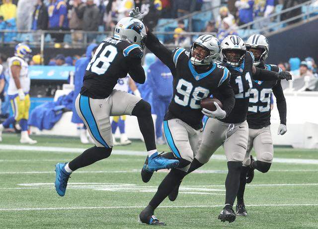 Panthers linebacker D.J. Wonnum, center, celebrated his recovery of a fumble by LA Rams QB Matthew Stafford with his teammates during an action at Bank of America Stadiumon Nov. 30.   Panthers defensive tackle Derrick Brown forced the fumble by applying pressure and chasing Stafford from the pocket. The Panthers defeated the Rams 31-28.