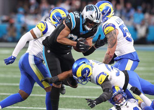 Carolina Panthers tight end Tommy Tremble fights for yardage as the Los Angeles Rams defense looks to make a tackle during action at Bank of America Stadium on Saturday, Jan. 10, 2026. The Rams defeated the Panthers 34-31.